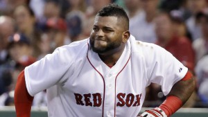 Boston Red Sox third baseman Pablo Sandoval grimaces after being hit on the foot by a pitch by Washington Nationals starter Stephen Strasburg in the third inning of a baseball game at Fenway Park in Boston, Tuesday, April 14, 2015. (AP Photo/Elise Amendola)